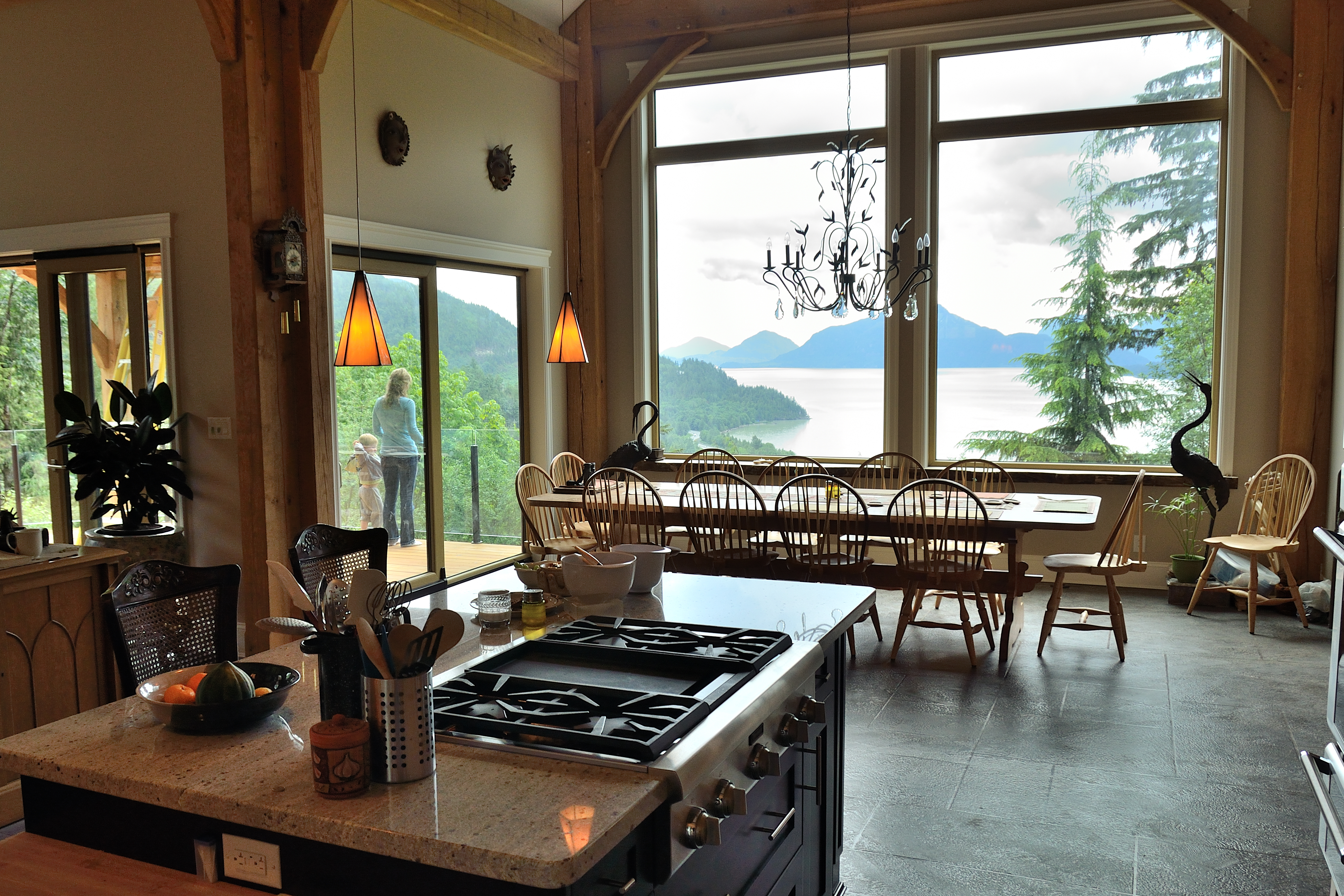 Luxury timber-frame kitchen and dining with BC waterfront view